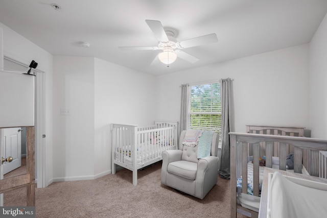 carpeted bedroom featuring baseboards and a ceiling fan