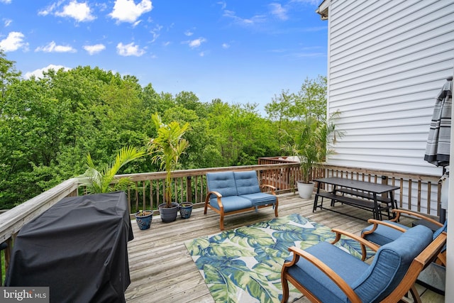 wooden terrace featuring a grill and outdoor lounge area