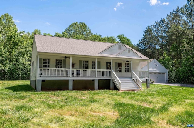 view of front of home with ceiling fan, an outdoor structure, a garage, and covered porch