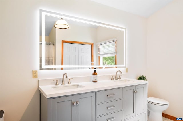 bathroom featuring toilet, double vanity, and a shower with shower curtain