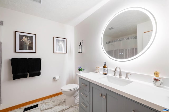 bathroom with marble finish flooring, baseboards, toilet, vanity, and curtained shower