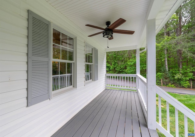 wooden terrace featuring covered porch and ceiling fan