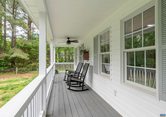 wooden terrace with a porch, a ceiling fan, and fence