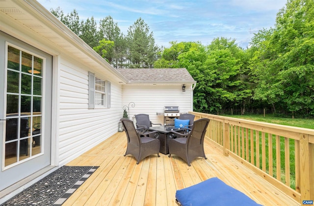 wooden deck with outdoor dining space and a grill