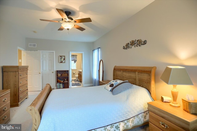 bedroom featuring ensuite bath and ceiling fan