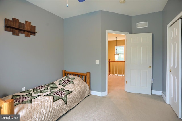 bedroom featuring carpet floors, baseboards, and a closet