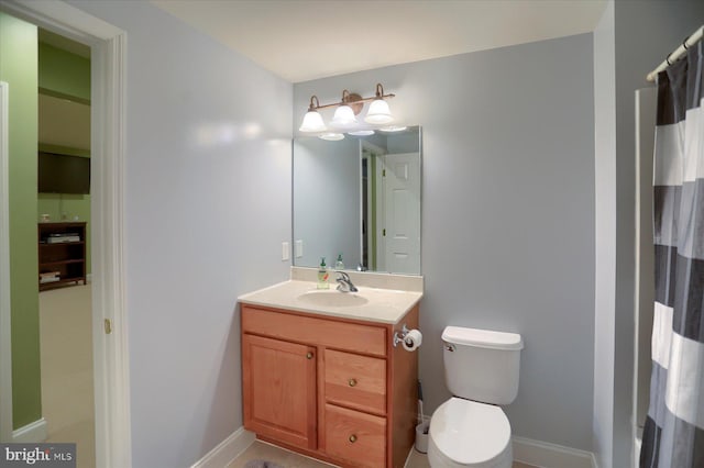 full bathroom featuring vanity, toilet, and baseboards