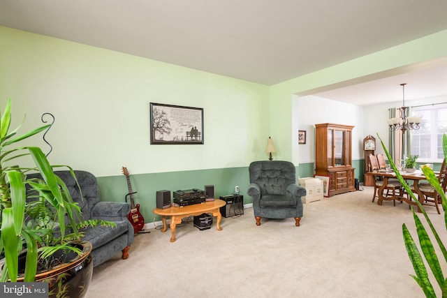 living room featuring a chandelier and carpet flooring