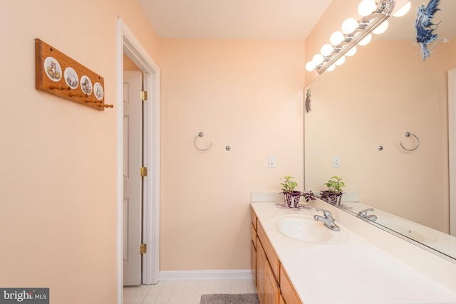 bathroom with baseboards, vanity, and tile patterned flooring
