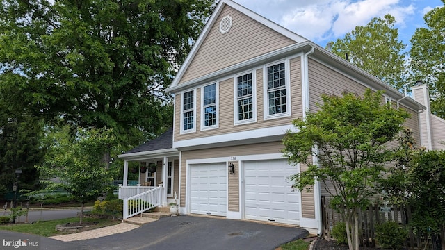 336 Deerpath Ave SW, Leesburg, VA 20175 - view of front of home with asphalt driveway, a garage, and a porch