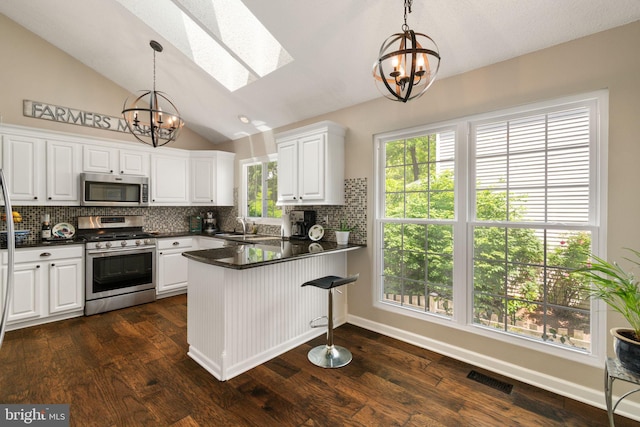 336 Deerpath Ave SW, Leesburg, VA 20175 - kitchen with stainless steel appliances, a chandelier, a skylight, a sink, and a peninsula