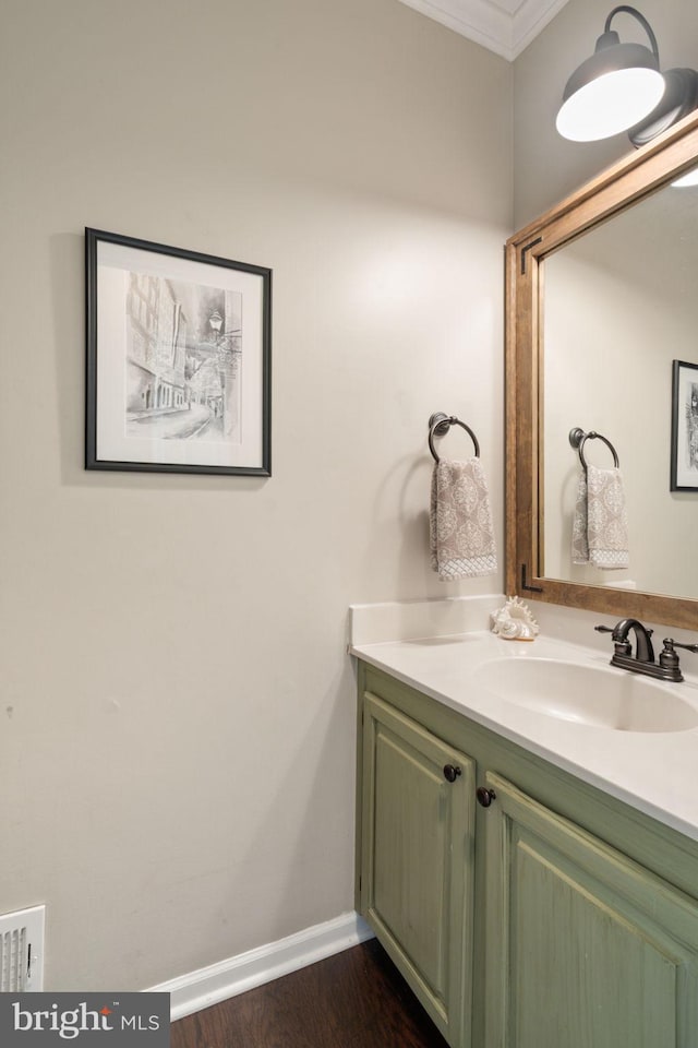336 Deerpath Ave SW, Leesburg, VA 20175 - bathroom with vanity, ornamental molding, baseboards, and wood finished floors