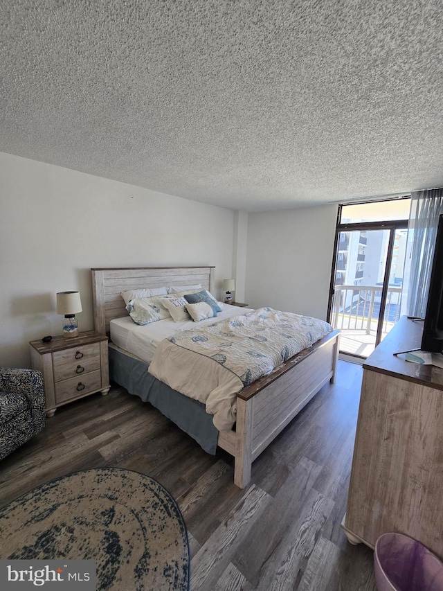 13100 Coastal Hwy Unit 1110, Ocean City, MD 21842 - bedroom with wood finished floors, a textured ceiling, and access to outside
