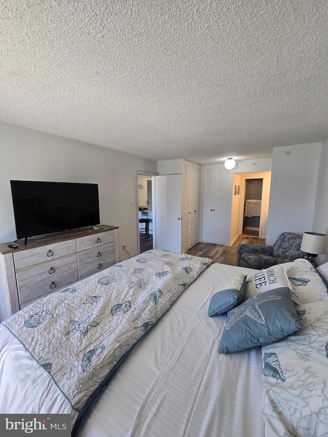 13100 Coastal Hwy Unit 1110, Ocean City, MD 21842 - bedroom with a textured ceiling, a closet, and wood finished floors