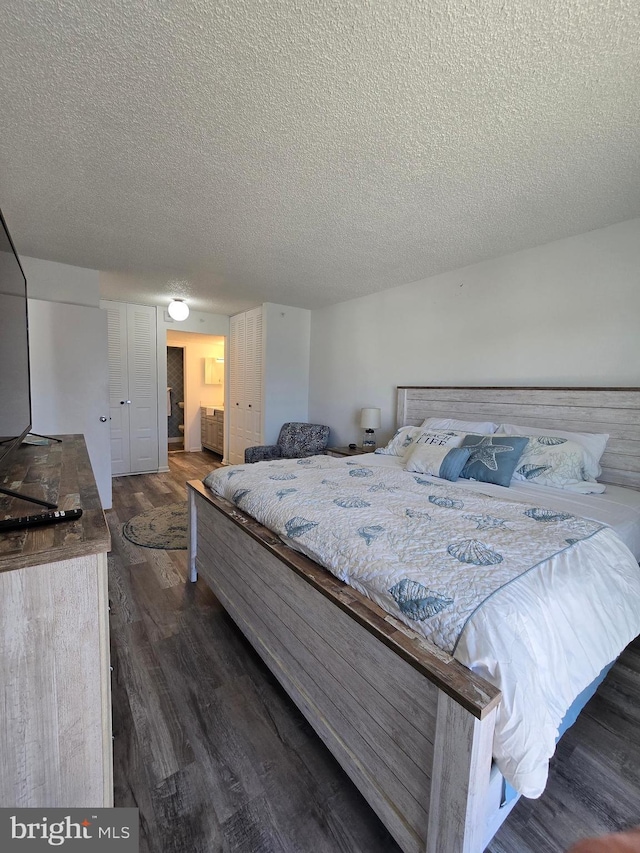 13100 Coastal Hwy Unit 1110, Ocean City, MD 21842 - bedroom featuring dark wood finished floors and a textured ceiling