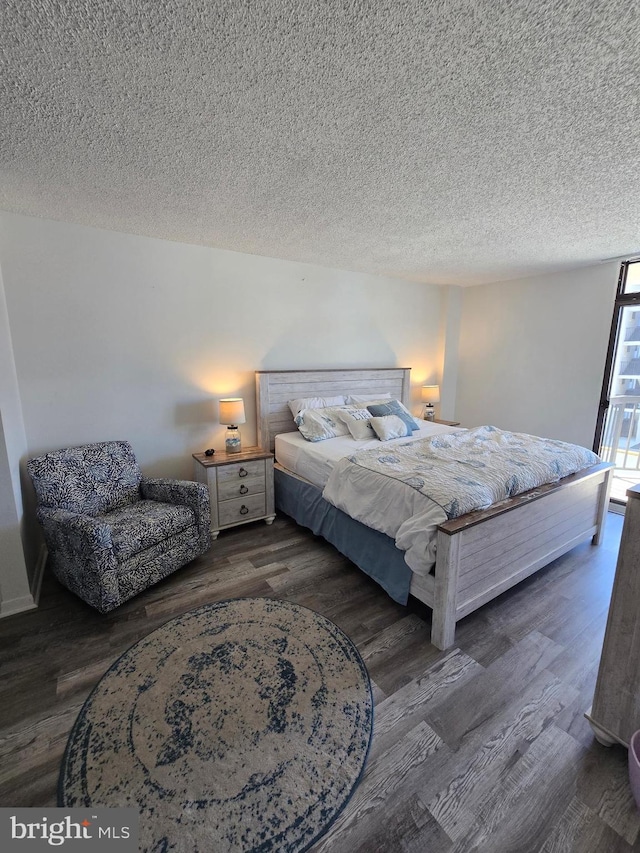 13100 Coastal Hwy Unit 1110, Ocean City, MD 21842 - bedroom with wood finished floors and a textured ceiling