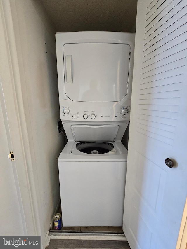 13100 Coastal Hwy Unit 1110, Ocean City, MD 21842 - laundry area featuring stacked washer / dryer and wood finished floors