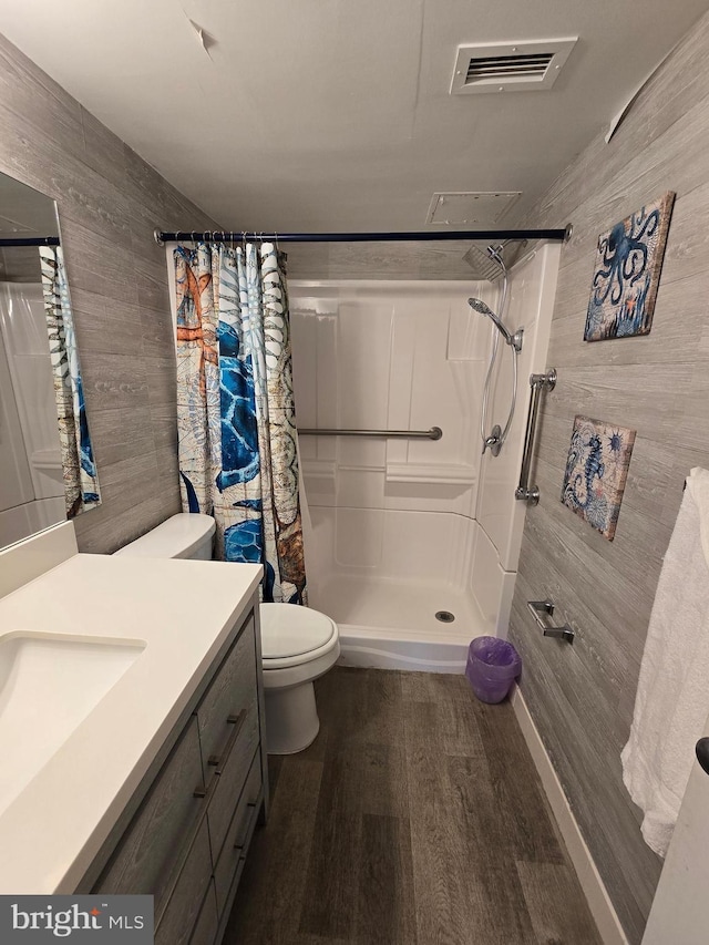 13100 Coastal Hwy Unit 1110, Ocean City, MD 21842 - full bathroom featuring wood walls, curtained shower, toilet, wood finished floors, and vanity