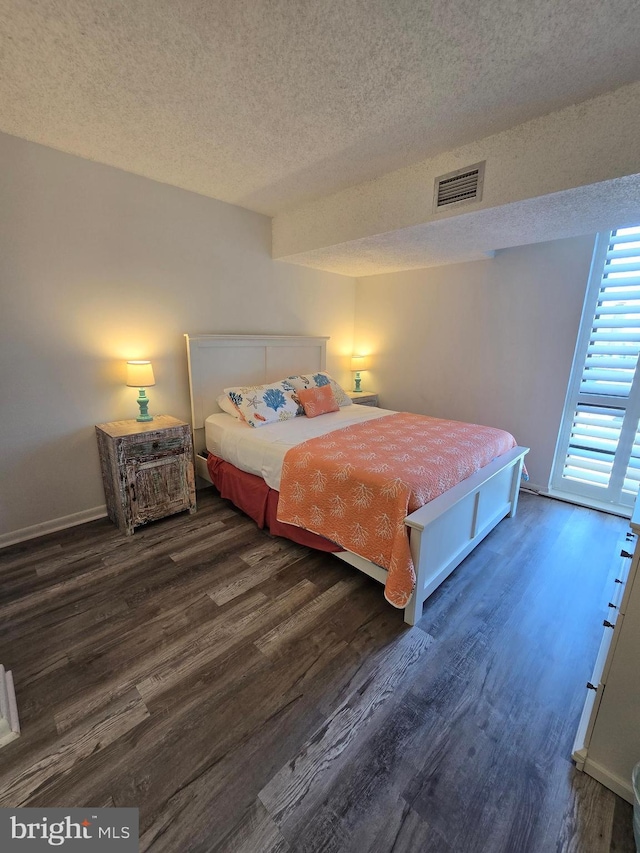 13100 Coastal Hwy Unit 1110, Ocean City, MD 21842 - bedroom featuring a textured ceiling, wood finished floors, and baseboards