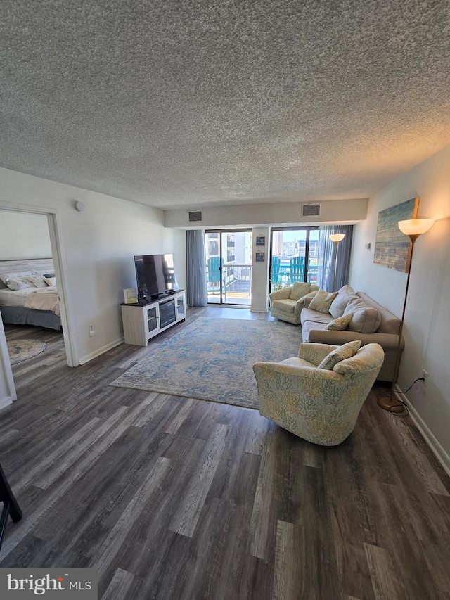 13100 Coastal Hwy Unit 1110, Ocean City, MD 21842 - living room featuring wood finished floors, a textured ceiling, and baseboards
