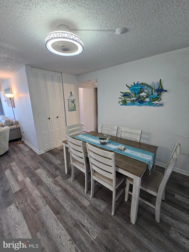 13100 Coastal Hwy Unit 1110, Ocean City, MD 21842 - dining space with a textured ceiling, wood finished floors, and baseboards