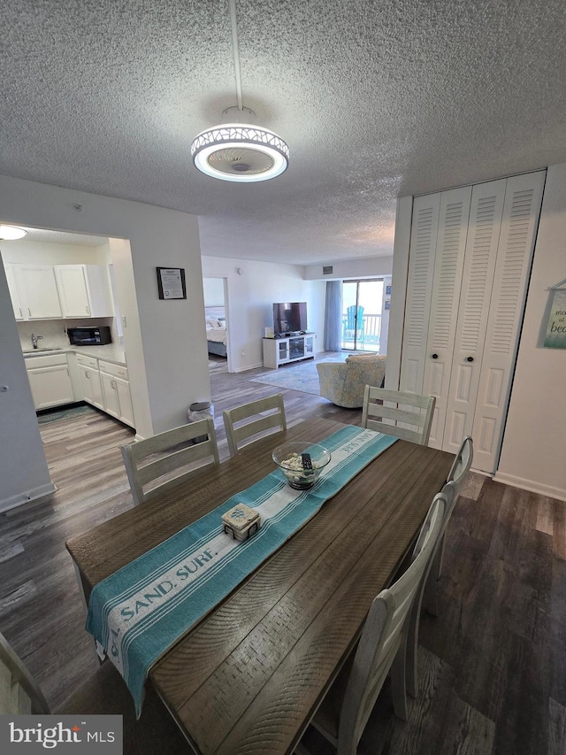 13100 Coastal Hwy Unit 1110, Ocean City, MD 21842 - dining space featuring wood finished floors and a textured ceiling