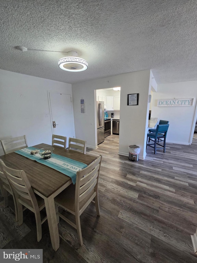 13100 Coastal Hwy Unit 1110, Ocean City, MD 21842 - dining space featuring a textured ceiling, wood finished floors, and baseboards