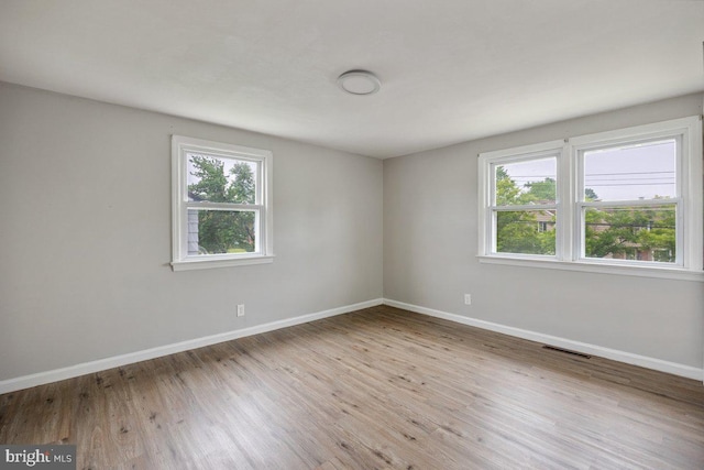 unfurnished room featuring wood finished floors and baseboards