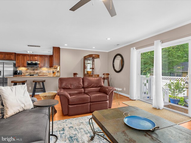 2039 Choptank Ave, Pasadena, MD 21122 - living area with ceiling fan, light wood-style floors, recessed lighting, crown molding, and baseboards