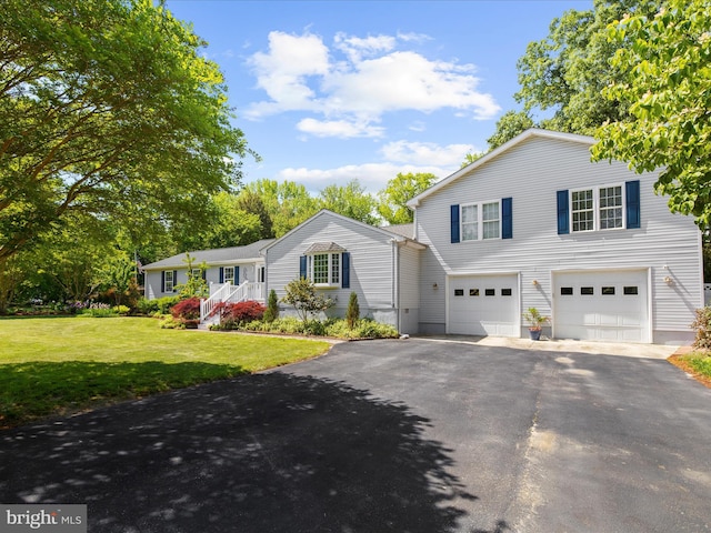 2039 Choptank Ave, Pasadena, MD 21122 - view of front of home with driveway, an attached garage, and a front yard