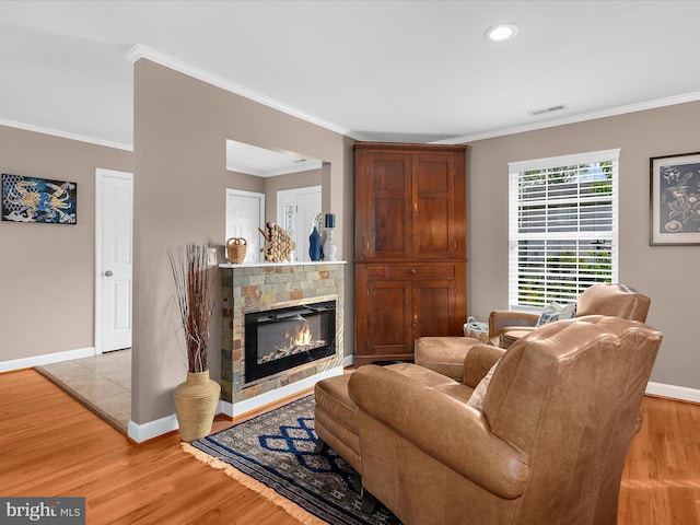 2039 Choptank Ave, Pasadena, MD 21122 - living room with ornamental molding, light wood-style floors, baseboards, a stone fireplace, and recessed lighting