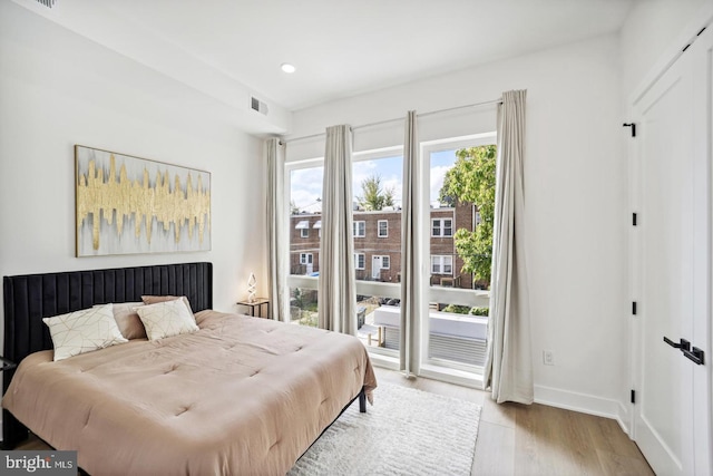 705 Quincy St NE Unit 5D, Washington, DC 20017 - bedroom with light wood finished floors, access to outside, baseboards, and recessed lighting