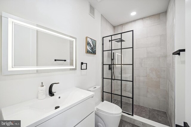 705 Quincy St NE Unit 5D, Washington, DC 20017 - bathroom featuring walk in shower, toilet, vanity, and recessed lighting