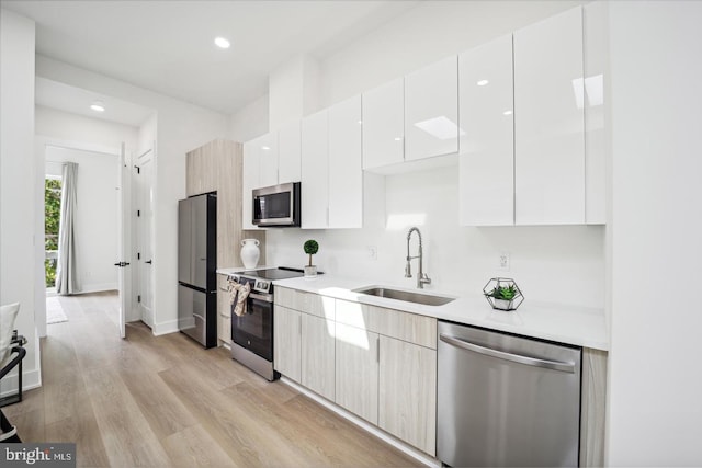 705 Quincy St NE Unit 5D, Washington, DC 20017 - kitchen featuring stainless steel appliances, a sink, modern cabinets, light countertops, and recessed lighting