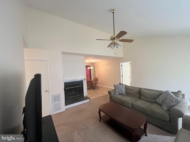 146 Diminish Dr, Newark, DE 19713 - carpeted living room with high vaulted ceiling, ceiling fan, and a chandelier
