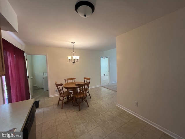 146 Diminish Dr, Newark, DE 19713 - dining area featuring a chandelier, baseboards, and independent washer and dryer