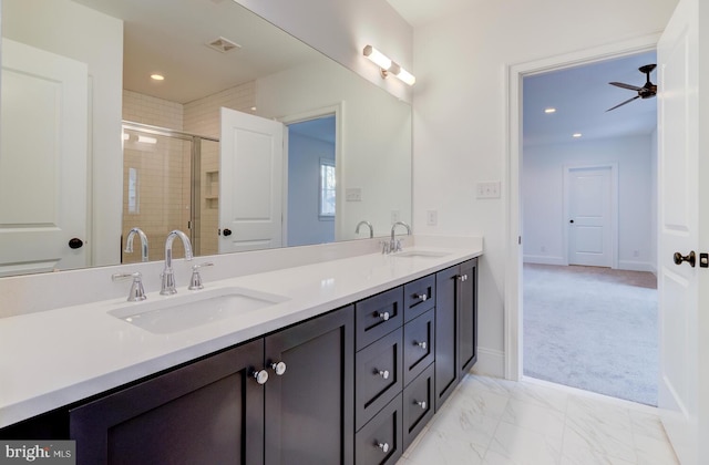 full bathroom featuring double vanity, a stall shower, recessed lighting, a ceiling fan, and baseboards