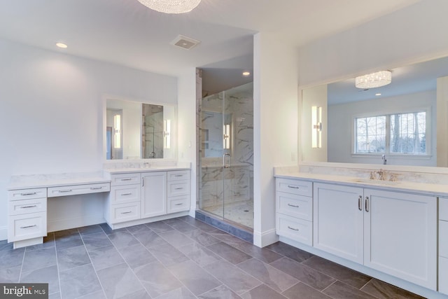 full bath featuring a marble finish shower, two vanities, recessed lighting, and baseboards
