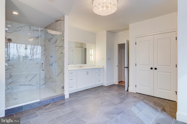 full bathroom with a marble finish shower, a chandelier, vanity, recessed lighting, and baseboards