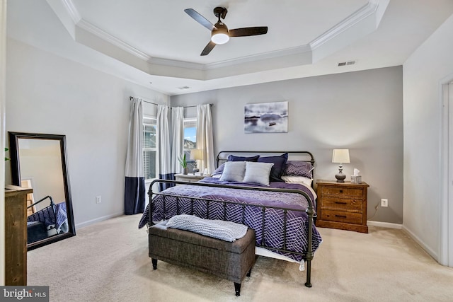 bedroom featuring crown molding, carpet floors, a raised ceiling, baseboards, and ceiling fan