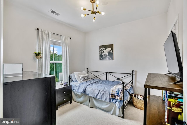carpeted bedroom featuring a chandelier