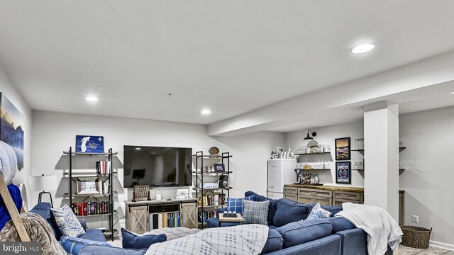 living area featuring recessed lighting and water heater