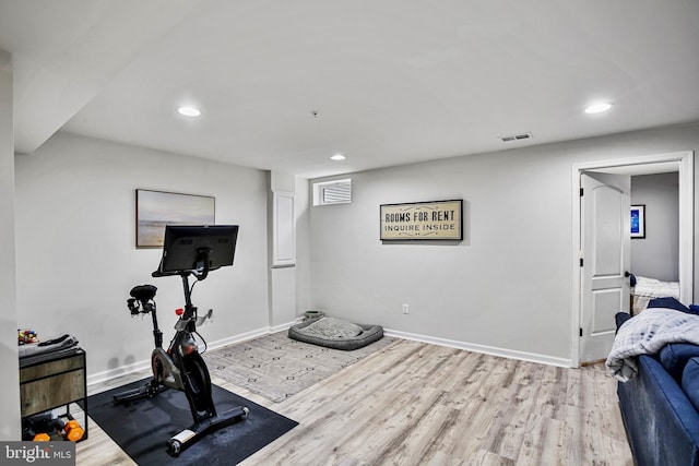 exercise area featuring wood finished floors, recessed lighting, and baseboards