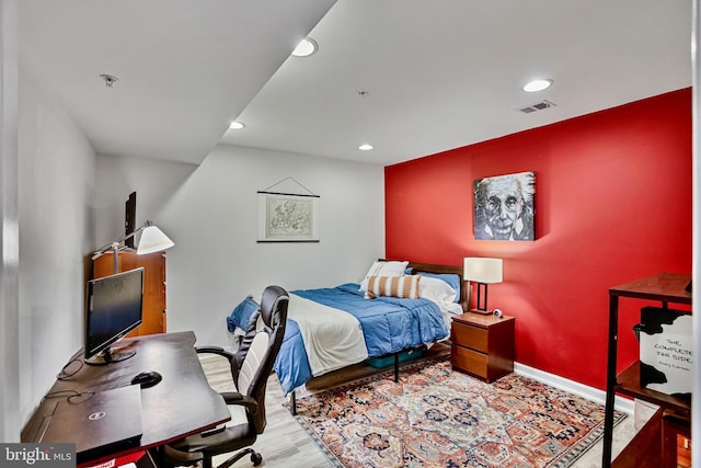 bedroom with recessed lighting, wood finished floors, and baseboards