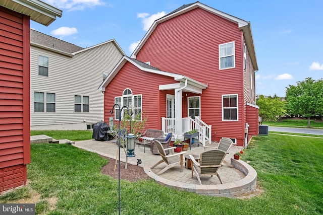 rear view of property with a patio area and a lawn