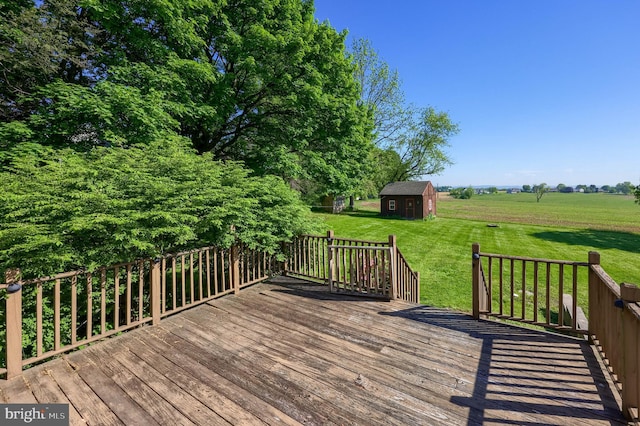 deck with an outdoor structure and a yard