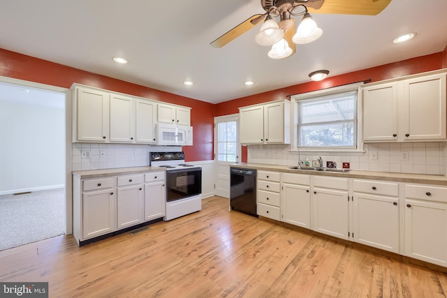 kitchen with electric stove, white microwave, black dishwasher, a sink, and a ceiling fan