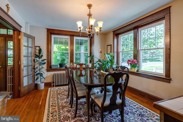 466 E Main St, Leola, PA 17540 - dining area with radiator heating unit, a chandelier, healthy amount of natural light, and wood finished floors