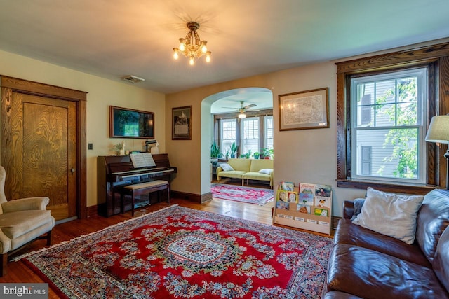 466 E Main St, Leola, PA 17540 - living room featuring arched walkways, wood finished floors, a chandelier, and baseboards