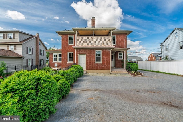 466 E Main St, Leola, PA 17540 - view of front facade with a chimney, fence, and brick siding